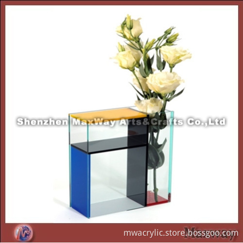 Colorized acrylic vase with a small table aside